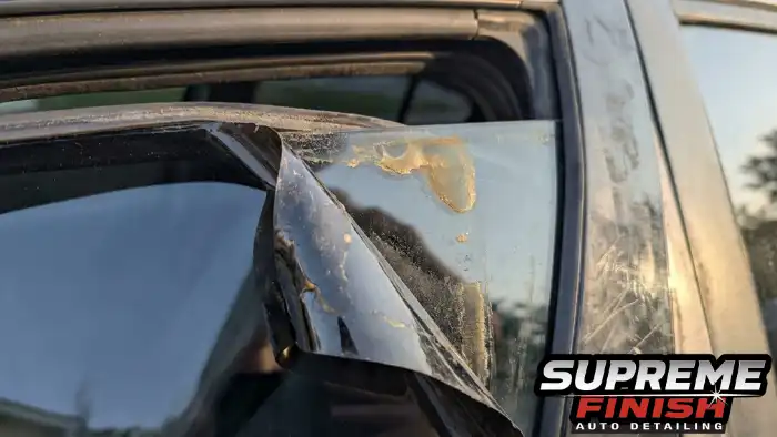 Low quality car window tint peeling off window