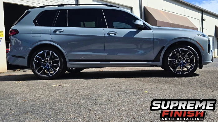 BMW X7 Ceramic coating side profile with SunTek tinted windows and black exterior trim.