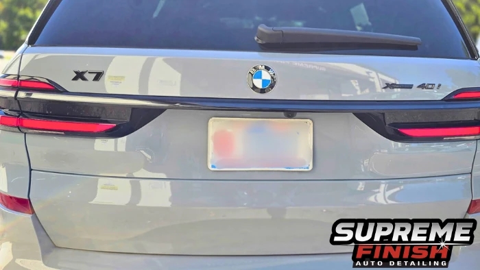 BMW X7 Ceramic coating rear view showing blacked-out X7 and xDrive40i badges on the glossy tailgate.
